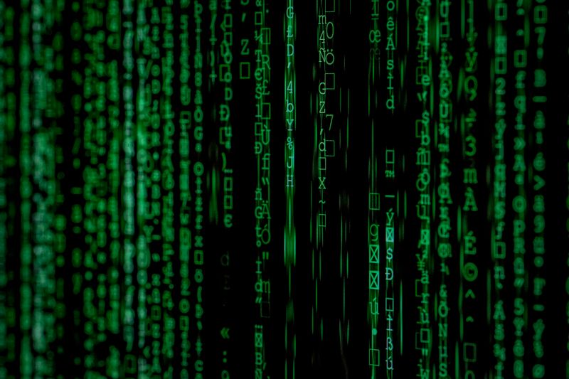 Green binary code on a dark background