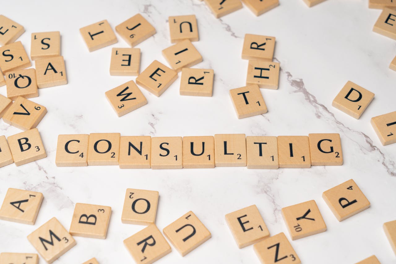 Home Scrabble tiles spelling 'Consulting' on a stylish marble surface symbolize strategic creativity.